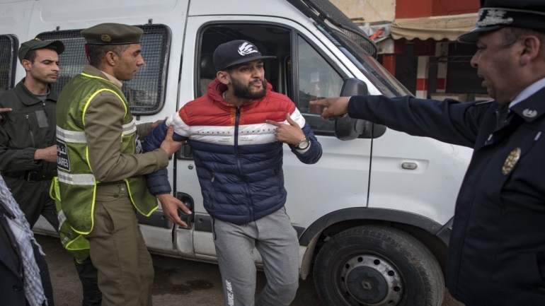 Moroccan authorities arrest a man who refused to remain in confinement as security forces instruct people to return to and remain at home as a measure against the COVID-19 coronavirus pandemic, in the capital Rabat's district of Takadoum, on March 27, 2020. (Photo by FADEL SENNA / AFP)