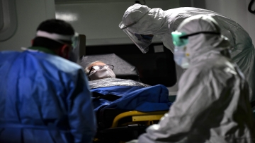 An elderly man with symptoms of the new coronavirus is carried into an ambulance to be transferred from the Carpe Diem nursing home to a hospital in Buenos Aires on May 7, 2020. (Photo by RONALDO SCHEMIDT / AFP)