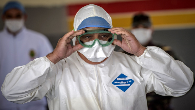 A member of the medical staff at Moroccos's military field hospital in Nouaceur, South of Casablanca, adjusts his goggles on April 18, 2020 as staff prepared to receive patients of the coronavirus pandemic. - Military hospitals have been reordered to maximise bed capacity, he said, adding that two field hospitals had been deployed to the coastal Casablanca region. Morocco had recorded 2,670 confirmed cases of coronavirus and 137 deaths, while over 280 have officially recovered. The North African kingdom has closed its borders and imposed a lockdown, enforced by security forces, to stem the spread of the disease. (Photo by FADEL SENNA / AFP) (Photo by FADEL SENNA/AFP via Getty Images)