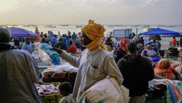 NOUAKCHOTT, MAURITANIA - DECEMBER 31: A plastic bag seller hawks his illegal wares at the fish market of Nouakchott, Mauritania. Mauritania outlawed plastic bags for environmental reasons but the bags are still popular for other reasons. (David Degner/Getty Images)