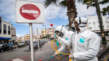 A Moroccan health ministry worker disinfects a "no entry" roadsign in the capital Rabat on March 22, 2020. - A public health state of emergency went into effect in the Muslim-majority country late on March 20, and security forces and the army have been deployed on the streets to combat the spread of COVID-19 coronavirus disease. People have been ordered to stay at home, and restrictions on public transport and travel between cities are also in place. (Photo by FADEL SENNA / AFP) (Photo by FADEL SENNA/AFP via Getty Images)