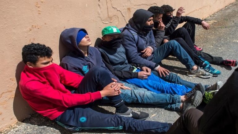 Young Moroccans gather at the harbour of the port city of Ceuta, a Spanish enclave perched on the northernmost tip of Morocco, on April 11, 2018, as they wait for the opportunity to board a boat for Europe. - In order to reach Ceuta or Melilla, another Spanish enclave, migrants must first scale the barbed wire fences which mark the only land borders between Europe and Africa. Those under 18 are hoping to benefit from European legislation which gives them greater protection than adult migrants and limits the chances of their being deported. (Photo by Fadel SENNA / AFP) (Photo credit should read FADEL SENNA/AFP/Getty Images)