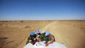 Trip to Smara teamsite. UN peacekeepers from Ghana, France, Bangladesh and Mongolia check the map for navigation in the vast area in Smara. Photo by Martine Perret/UN. 19 June 2010.