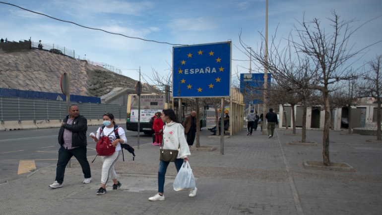 People wait to cross at border from Ceuta with Morocco on March 13, 2020. - Morocco closed the border with Ceuta and Melilla, Spain's two North African enclaves to prevent the spread of the deadly coronavirus. After Italy, Spain is the worst-hit country in Europe, with officials taking numerous measures to try and halt the spread of the deadly virus, with schools shuttered across the country along with museums, theatres, gyms and sports facilities. (Photo by JORGE GUERRERO / AFP)