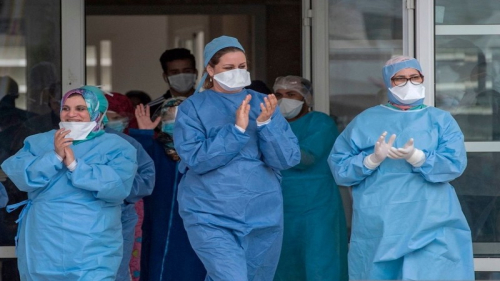 Members of the medical staff rejoice as patients who recovered from the Covid-19 disease caused by the novel coronavirus, leave a hospital in the city of Sale, north of the Moroccan capital Rabat, on April 12, 2020. (Photo by FADEL SENNA / AFP) (Photo by FADEL SENNA/AFP via Getty Images)