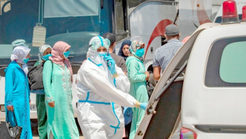 Moroccans, who tested positing for Covid-19, arrive in a parking lot in the town of Moulay Bousselham, north of the capital Rabat, on June 20, 2020, ahead of being transferred to a medical center in another city. - Morocco reported a record single-day rise in novel coronavirus cases on Friday after an outbreak was discovered in red fruit packing plants in a rural area northeast of Kenitra city, prompting Rabat to tighten restrictions in the region. The North African kingdom reported more than 500 cases on Friday, mainly in Kenitra, having recorded on average fewer than 100 new COVID-19 cases daily since confirming its first cases in early March. (Photo by FADEL SENNA / AFP) (Photo by FADEL SENNA/AFP via Getty Images)