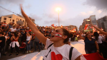 TOPSHOT - Lebanese demonstrators chant slogans as they take part in a rally in the capital Beirut's downtown district on October 20, 2019. - Thousands continued to rally despite calls for calm from politicians and dozens of arrests. The demonstrators are demanding a sweeping overhaul of Lebanon's political system, citing grievances ranging from austerity measures to poor infrastructure. (Photo by Anwar AMRO / AFP) (Photo by ANWAR AMRO/AFP via Getty Images)