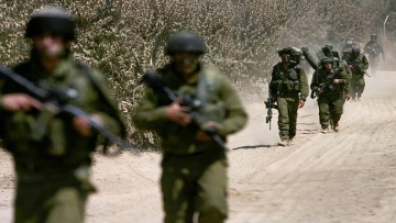 LEBANON BORDER, ISRAEL - AUGUST 01: (ISRAEL OUT) Israeli soldiers move toward the Lebanese border during a mission August 1, 2006 on the Israeli-Lebanese border. Israel has reportedly widened its ground offensive into southern Lebanon and could last for up to two weeks. (Photo by Uriel Sinai/Getty Images)