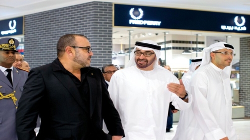 ABU DHABI, UNITED ARAB EMIRATES - October 29, 2013: HH General Sheikh Mohamed bin Zayed Al Nahyan Crown Prince of Abu Dhabi Deputy Supreme Commander of the UAE Armed Forces (C), and His Majesty King Mohammed VI of Morocco (L), tour The Galleria shopping mall at Sowwah Square on Al Maryah Island, after the opening ceremony. Seen with HE Khaldoon Khalifa Al Mubarak CEO and Managing Director Mubadala and Chairman of the Executive Affairs Authority (R). ( Ryan Carter / Crown Prince Court - Abu Dhabi ) ---