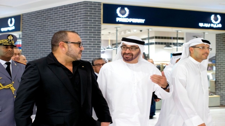 ABU DHABI, UNITED ARAB EMIRATES - October 29, 2013: HH General Sheikh Mohamed bin Zayed Al Nahyan Crown Prince of Abu Dhabi Deputy Supreme Commander of the UAE Armed Forces (C), and His Majesty King Mohammed VI of Morocco (L), tour The Galleria shopping mall at Sowwah Square on Al Maryah Island, after the opening ceremony. Seen with HE Khaldoon Khalifa Al Mubarak CEO and Managing Director Mubadala and Chairman of the Executive Affairs Authority (R). ( Ryan Carter / Crown Prince Court - Abu Dhabi ) ---