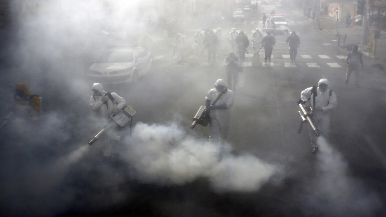 TOPSHOT - Iranian Firefighters disinfect streets in the capital Tehran in a bid to halt the wild spread of coronavirus on March 13 2020. - Iranian forces will clear the streets nationwide within 24 hours and all citizens will be checked for the new coronavirus in a bid to halt its spread, the military said. (Photo by - / AFP) (Photo by -/AFP via Getty Images)