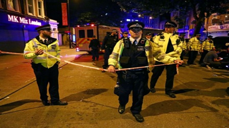 Police officers attend to the scene after a vehicle collided with pedestrians in the Finsbury Park neighborhood of North London, Britain June 19, 2017. REUTERS/Neil Hall