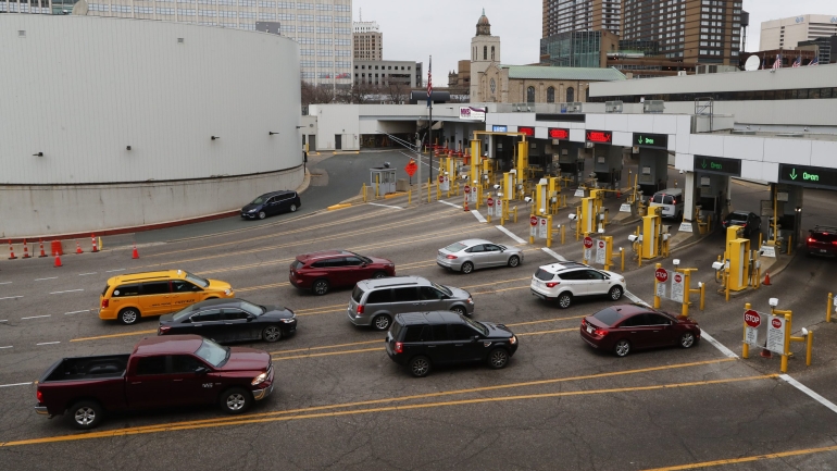 Vehicles enter the United States as a minivan drives to Canada in the Detroit-Windsor Tunnel in Detroit, Monday, March 16, 2020. Canadian Prime Minister Justin Trudeau says he is closing his country's borders to anyone not a citizen, an American or a permanent resident amid the coronavirus outbreak. (AP Photo/Paul Sancya)